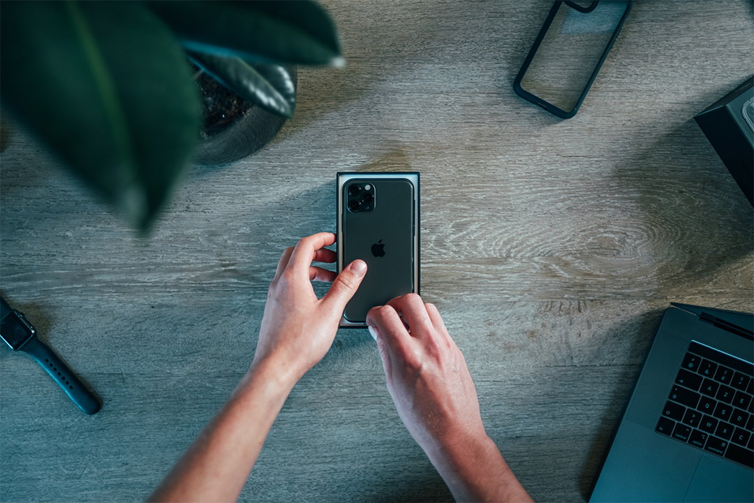 A person is unboxing a new iPhone
