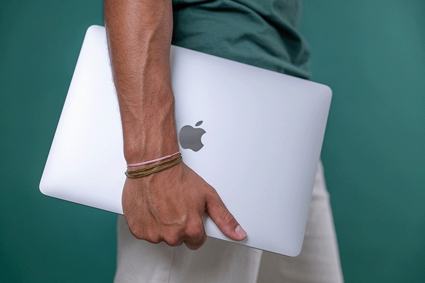 Student holding refurbished MacBook from refurbed.ie