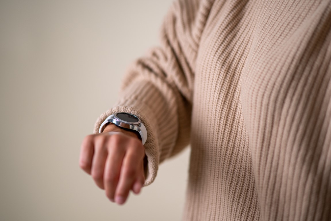 Person wearing a Samsung Galaxy Watch and looking at it